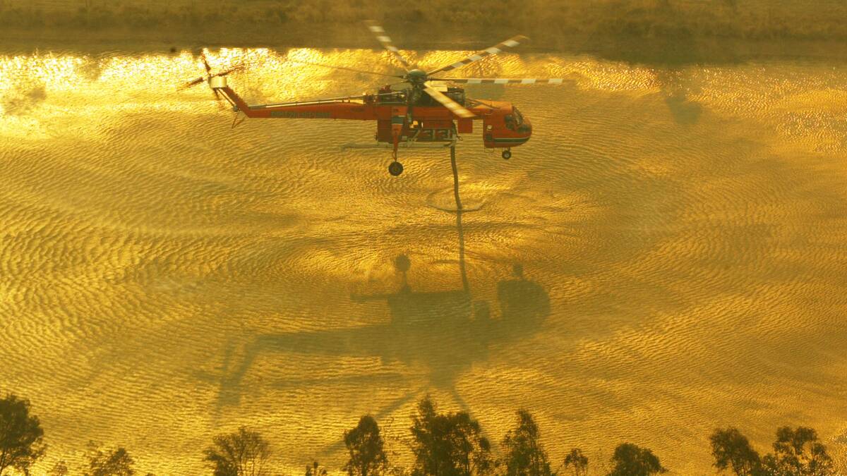 An Eriksson Air Crane fills up with water during the bushfires. Picture by Paul Sadler