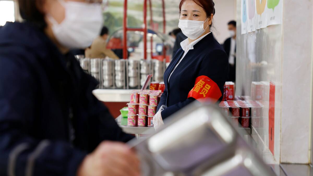A staff member supervises the "Clean Plate" campaign among staff at a canteen of a central government institution in Beijing. Picture: Getty Images