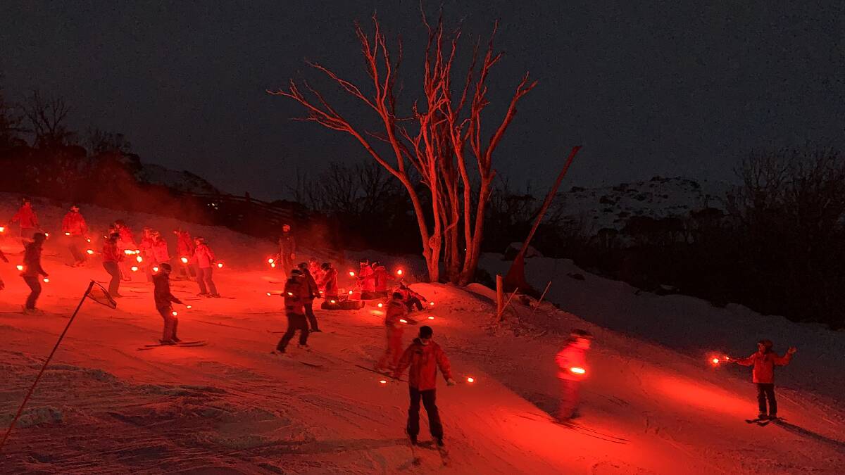 The first of 50 skiers head down the slopes as part of Thredbos Saturday-night flare run. Picture: Tim the Yowie Man