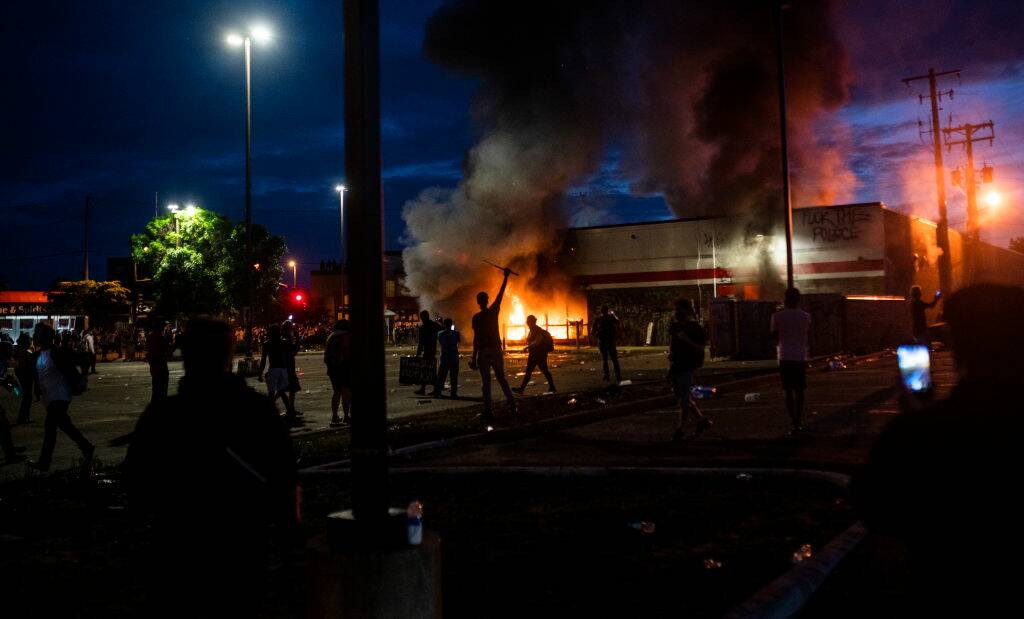 A fire burns inside a Minneapolis store as businesses were looted and damaged during protests after the police killing of George Floyd. Picture: Getty Images