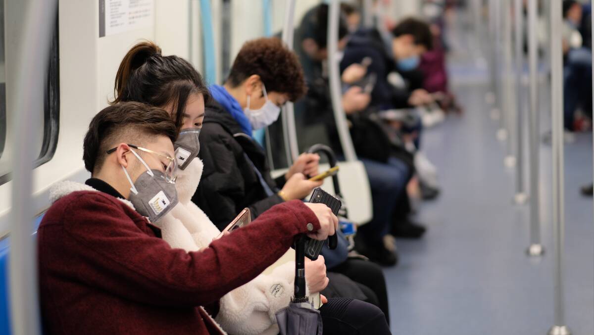 People in Shanghai wear surgical masks on the subway as the coronavirus spreads. Picture: Shutterstock