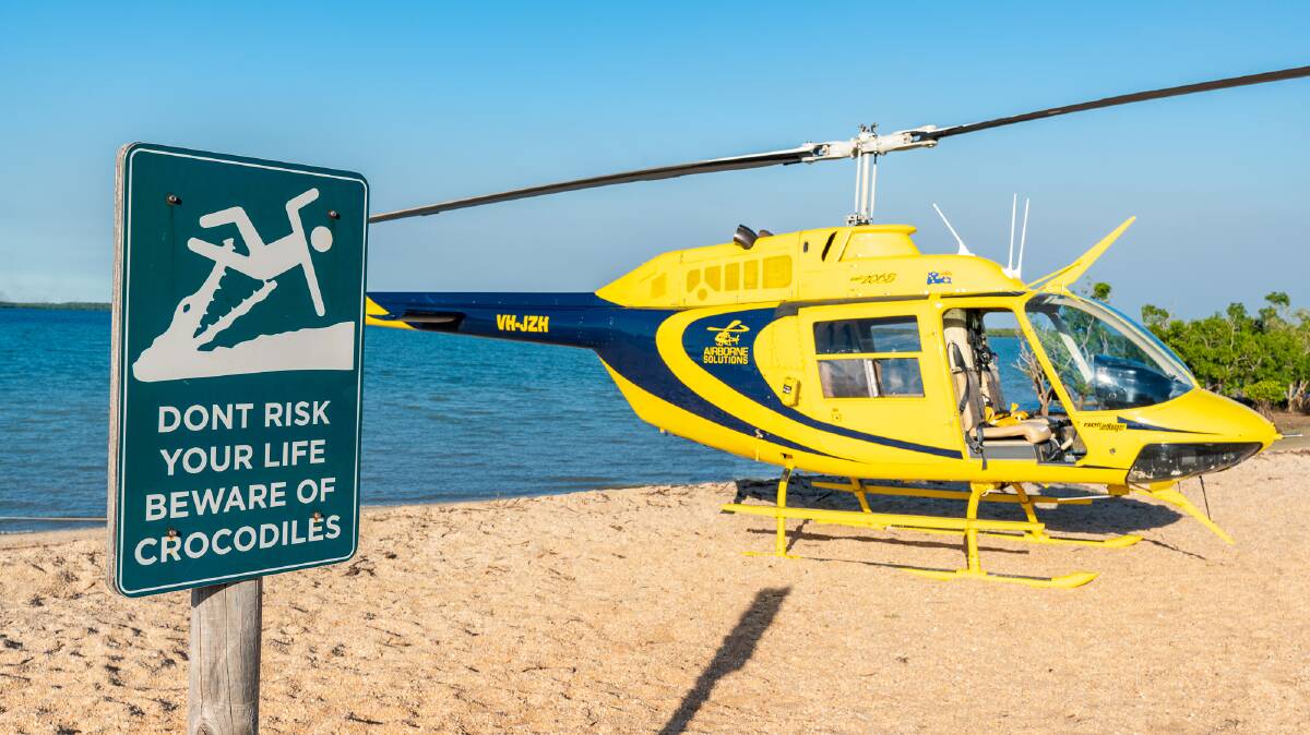 The helicopter lands right on the beach at the Crab Claw Island Resort. Picture: Michael Turtle