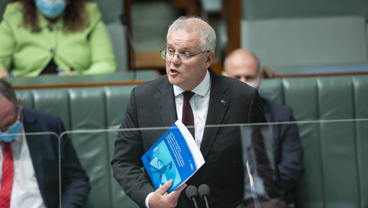 Prime Minister Scott Morrison with the Jenkins report during question time on Tuesday. Picture: Keegan Carroll