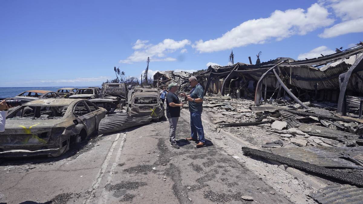 Governor of Hawaii Josh Green, left, and Maui county mayor Richard Bissen jnr speak during a tour of wildfire damage. Picture AP