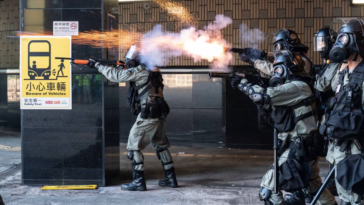 Riot police fire teargas and rubber bullets as protesters attempt to leave The Hong Kong Polytechnic University on Monday. Picture: Getty Images