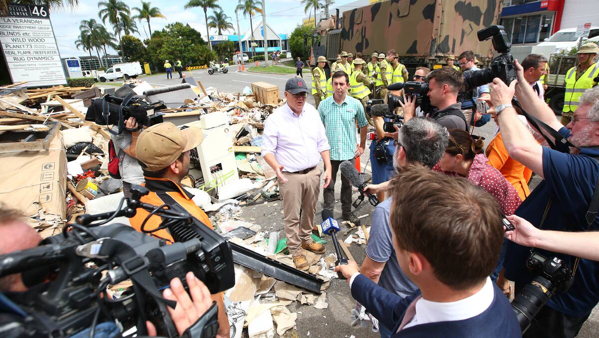 Scott Morrison and ADF personnel visit a flood-affected street in Brisbane this week. Picture: Getty Images 