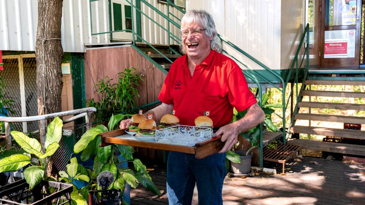 Kai Hansen brings out buffalo burgers at his bar on Goat Island. Picture: Michael Turtle