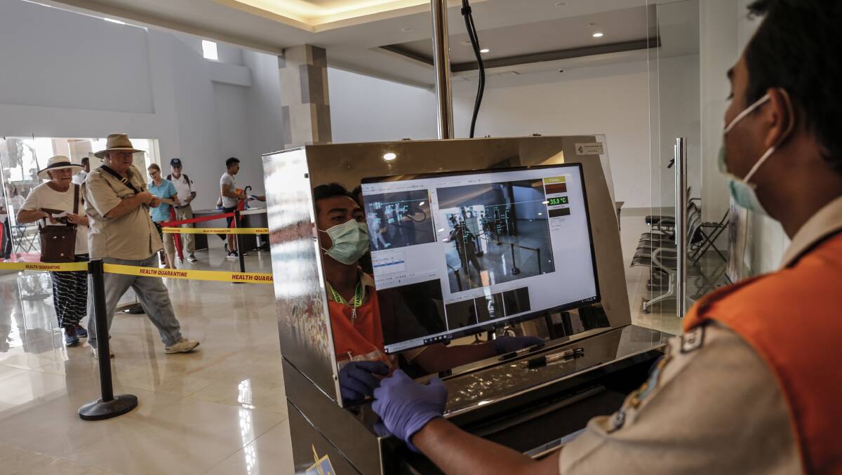 A port health officer observes cruise passengers' body temperatures at Benoa cruise port in Denpasar last month. Australia and Indonesia's trade is worth almost $12 billion each year. Picture: Getty Images
