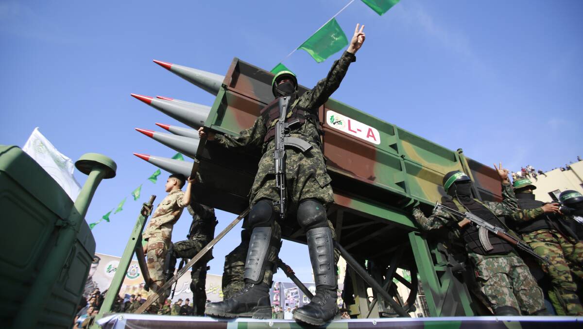 Armed Hamas militants seen next to missiles during an anti-Israel rally in the northern Gaza Strip. Picture: Getty Images