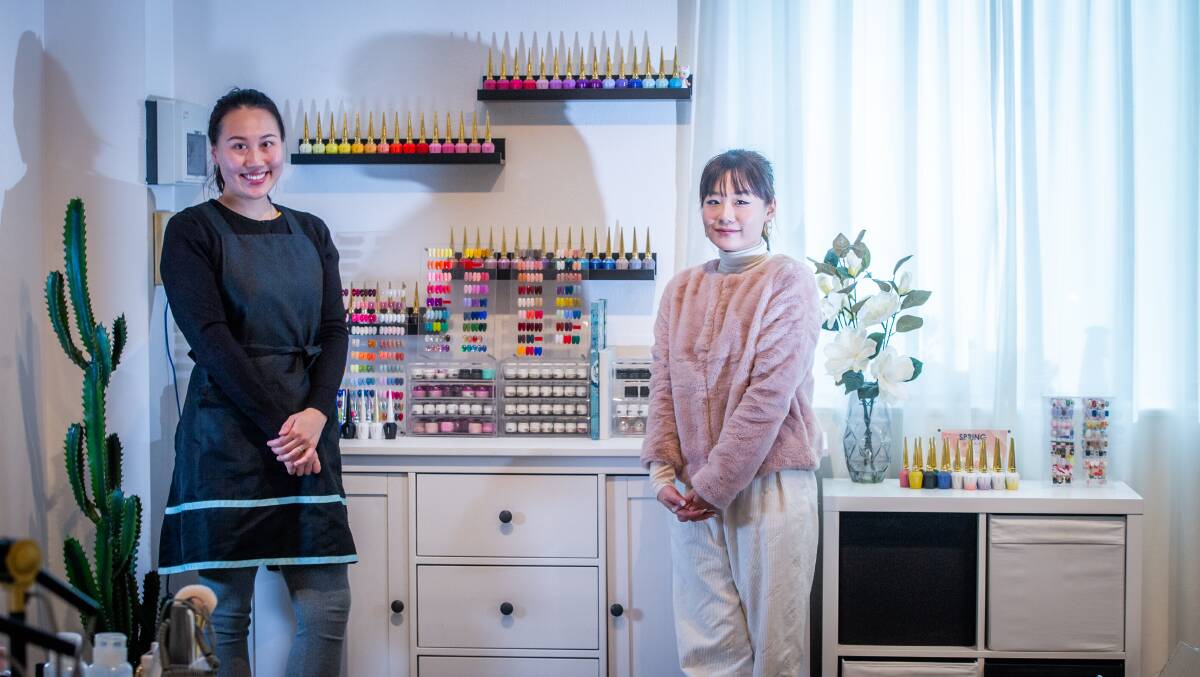 Nono Qiao (left) and Elva Zhao prepare to reopen their salon. Picture: Karleen Minney