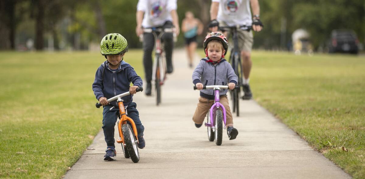 Hugh Tempra and Asher Hogan, both three-years-old, getting ready for the Big Canberra Bike Ride. Picture: Keegan Carroll