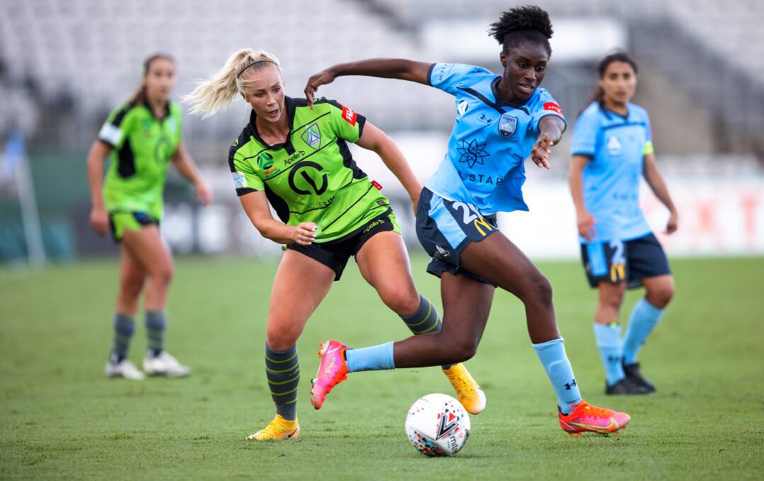 Lauren Keir challenges Princess Ibini. Canberra United's squad is nearing completion for the upcoming season. Picture: Sitthixay Ditthavong.