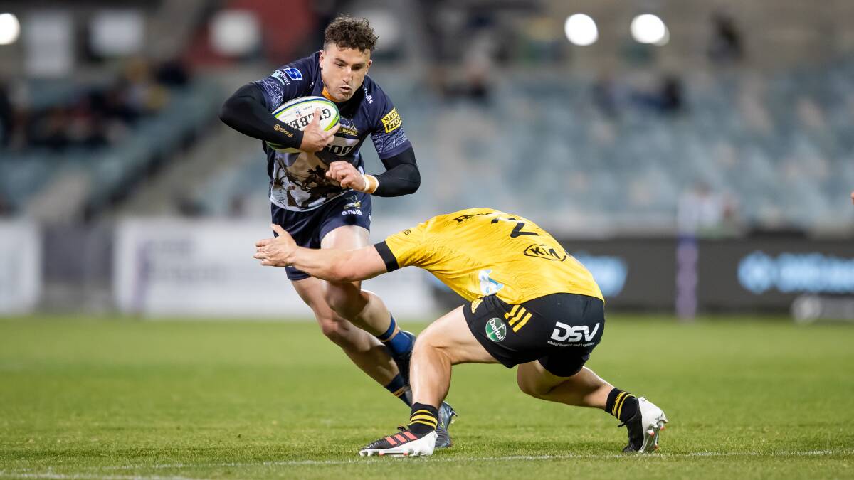 Brumbies fullback Tom Banks takes on Hurricanes hooker Dane Coles. Picture: Sitthixay Ditthavong