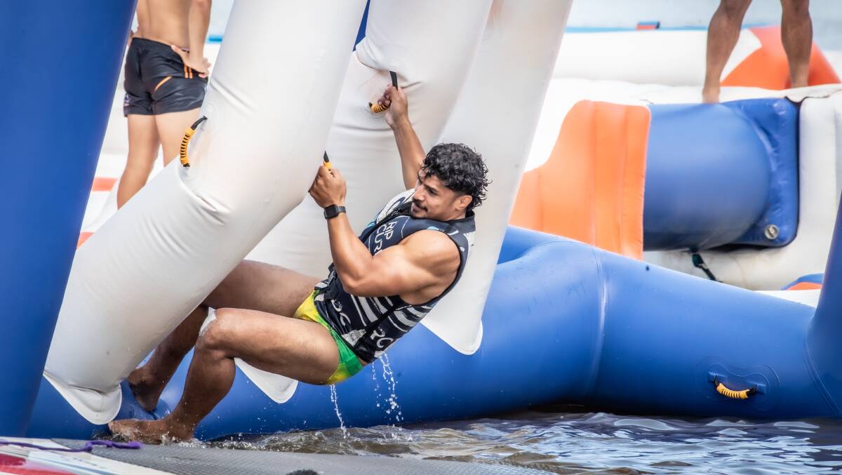 Pete Samu navigates the tricky obstacle at Canberra Aqua Park. Picture: Karleen Minney