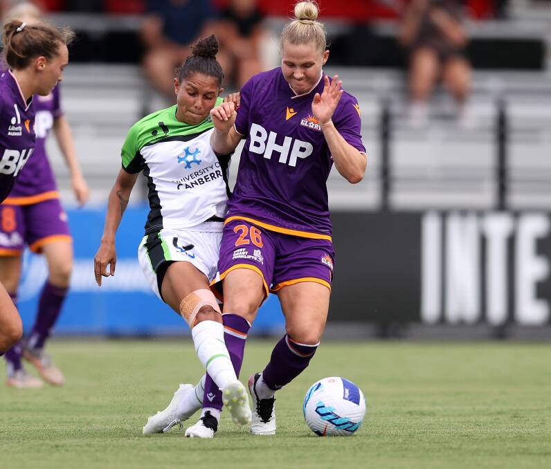 Canberra striker Allira Toby goes toe to toe with Perth's Danish international Mie Leth Jans in Sydney on Wednesday night. Picture: Getty