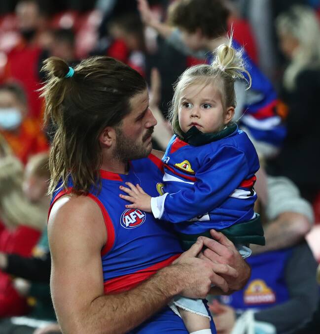Josh Bruce and daughter Poppy. Bruce will miss Saturday's AFL grand final through injury. Picture: Getty