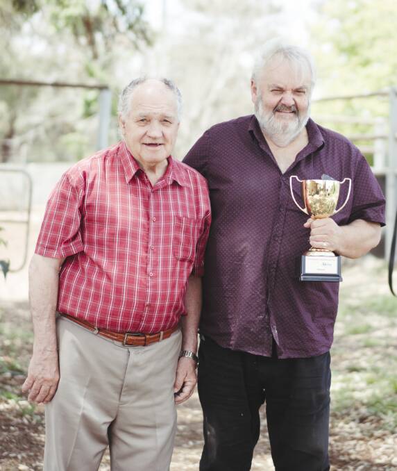 Queanbeyan Racing Club chief Brendan Comyn (right), and veteran trainer Frank Cleary with the Queanbeyan Cup. Picture: Dion Georgopoulos