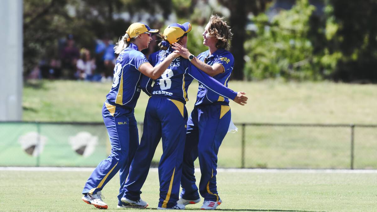 Captain Angela Reakes celebrates a catch with her Meteors teammates. Picture: Dion Georgopoulos