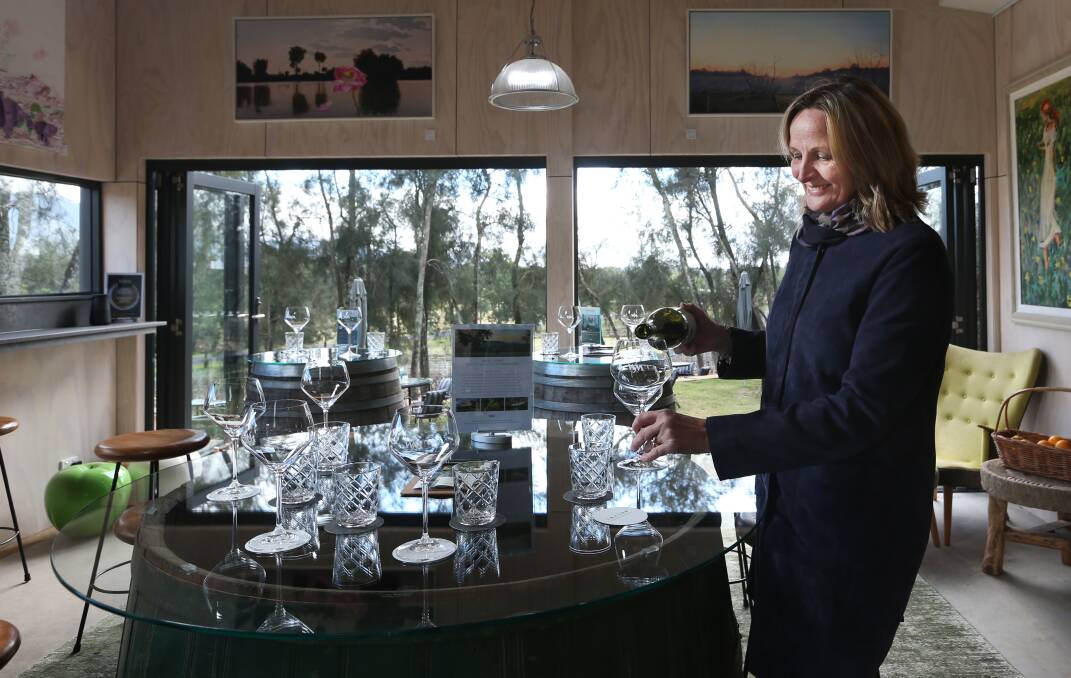 To her door: Karin Adcock serves a glass of Winmark Wines' 2019 chardonnay at the estate's cellar door in the Hunter Valley. Picture: Simone De Peak 