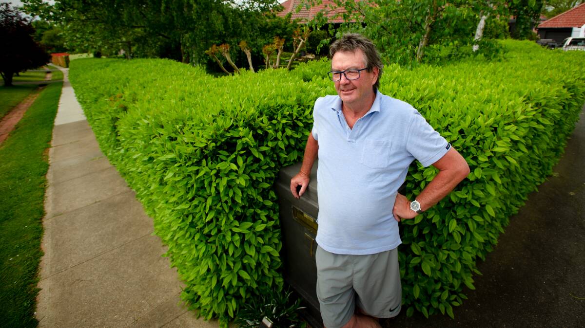 Dan Carey with his yet-to-be-trimmed hedge in Griffith. Picture: Elesa Kurtz