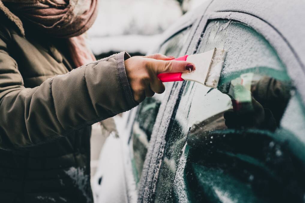 Investing in a good quality, long handled ice scraper is the fastest and easiest way to clear windscreen ice and frost. Picture: Shutterstock