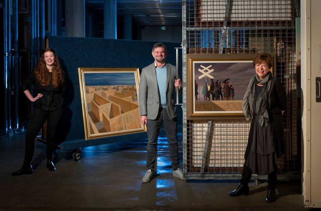 Curator Rebecca Edwards, National Gallery of Australia director Nick Mitzevich and head of Australian art Deborah Hart with Jeffrey Smart's Labyrinth and Waiting for the Train. Picture: Supplied