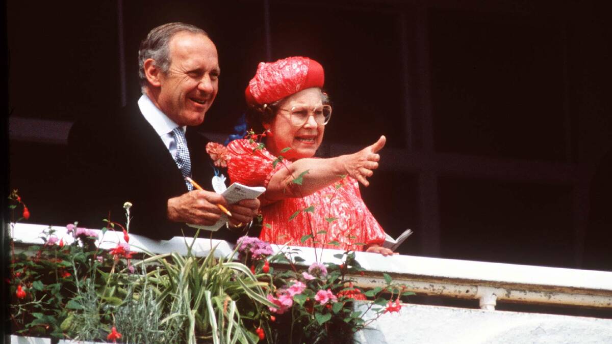 Queen Elizabeth at the Epsom Derby in Surrey with her Private Secretary William Heseltine, 1989. Picture Getty Images 
