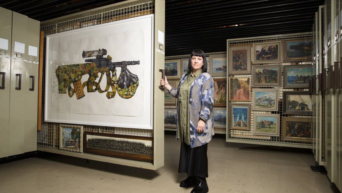 Australian War Memorial art collection head Laura Webster, with a work by eX de Medici. Picture: Keegan Carroll
