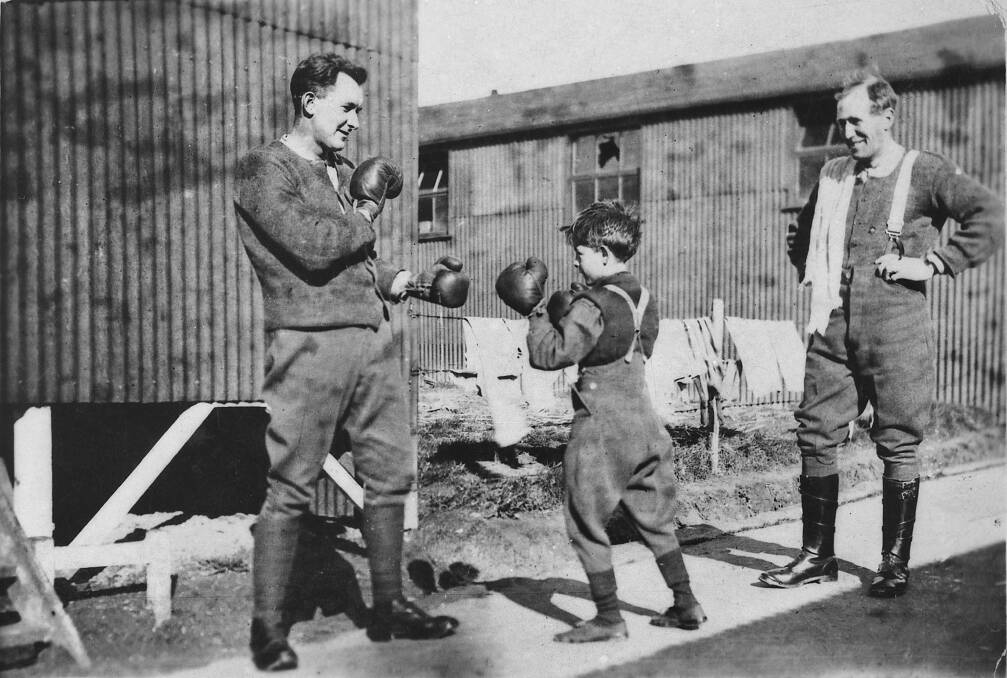 Henri Tovell boxing at Hurdcott Camp with two unidentified members of the AIF. Picture: Australian War Memorial 