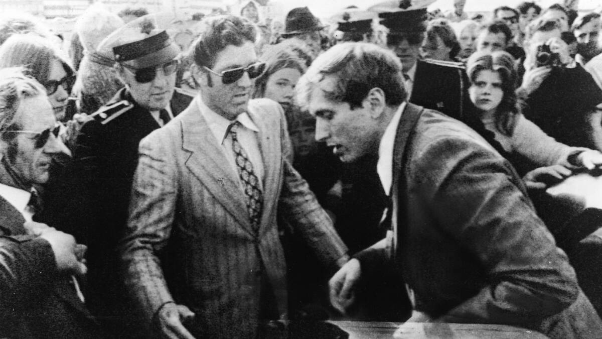 The temperamental Bobby Fischer exits a car into a waiting crowd which includes several uniformed Icelandic policemen as he arrives for his third match with Soviet world champion Boris Spassky at the Reykjavik Exhibition Hall in 1972. Picture: Getty Images
