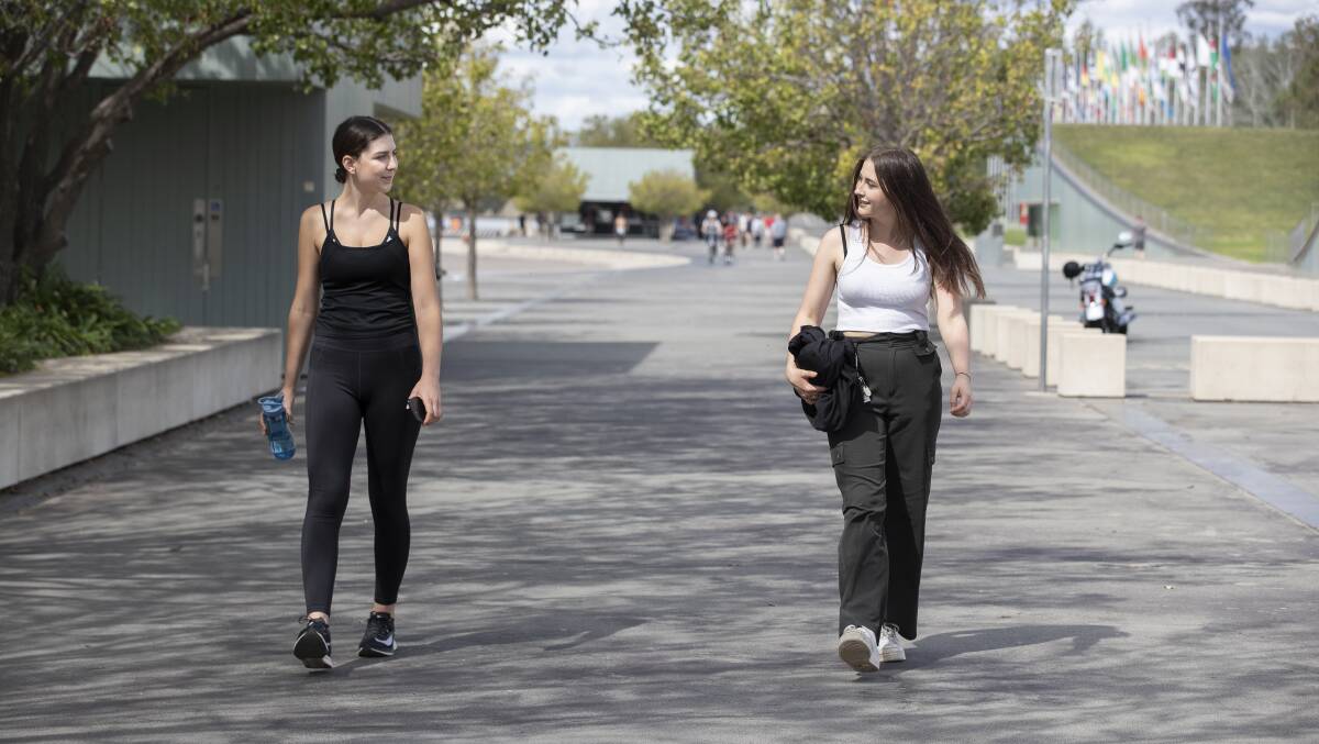 Social distancing, Canberra-style. Rose Corcoran and Rosie Flannery getting some exercise at Queen Elizabeth Terrace. Picture: Sitthixay Ditthavong
