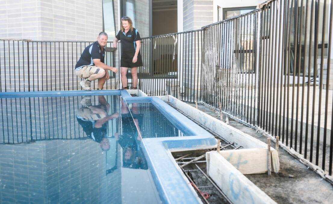John and Charissa, who run Nulook Pools, with a recently installed pool in Canberra. Picture by Karleen Minney