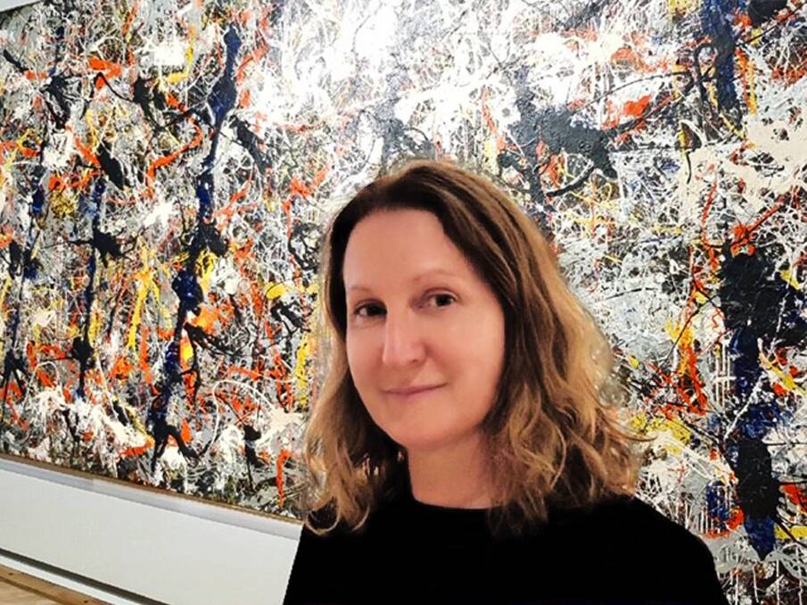 Angela O'Keeffe, seeing the world through the eyes of Jackson Pollock's Blue Poles, the work behind her. Picture: Supplied