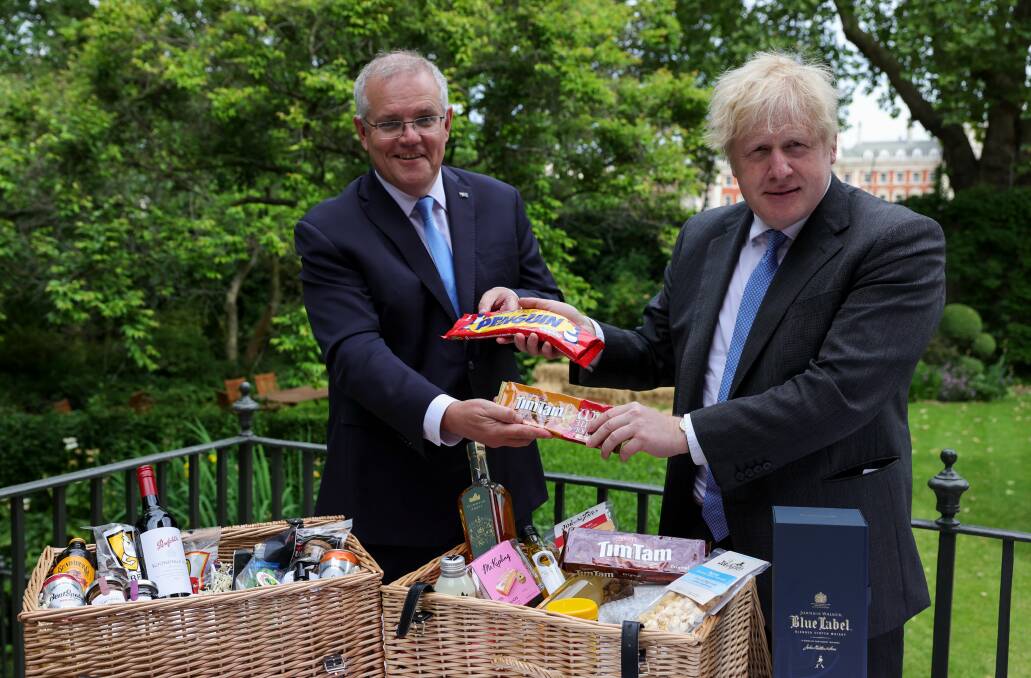 "The deal is done" - Scott Morrison and Boris Johnson exchange local delicacies, including Canberra's own Bentspoke beer. Picture: Twitter