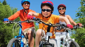 Family fun: Don't buy a bike that 'they will grow into' as this can be dangerous and frustrating for the child. Photo: Shutterstock