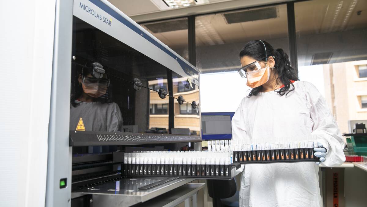  Canberra Health Services lab worker Sadikshya Rijal processes COVID-19 PCR tests. Picture: Keegan Carroll