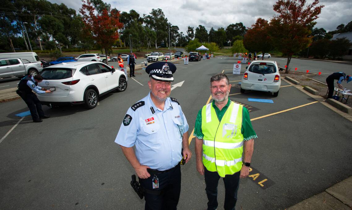 Inspector Brett Booth with Neighbourhood Watch ACT president Laurie Blackwell at a Project Safe Plate event in Holt. Picture: Elesa Kurtz