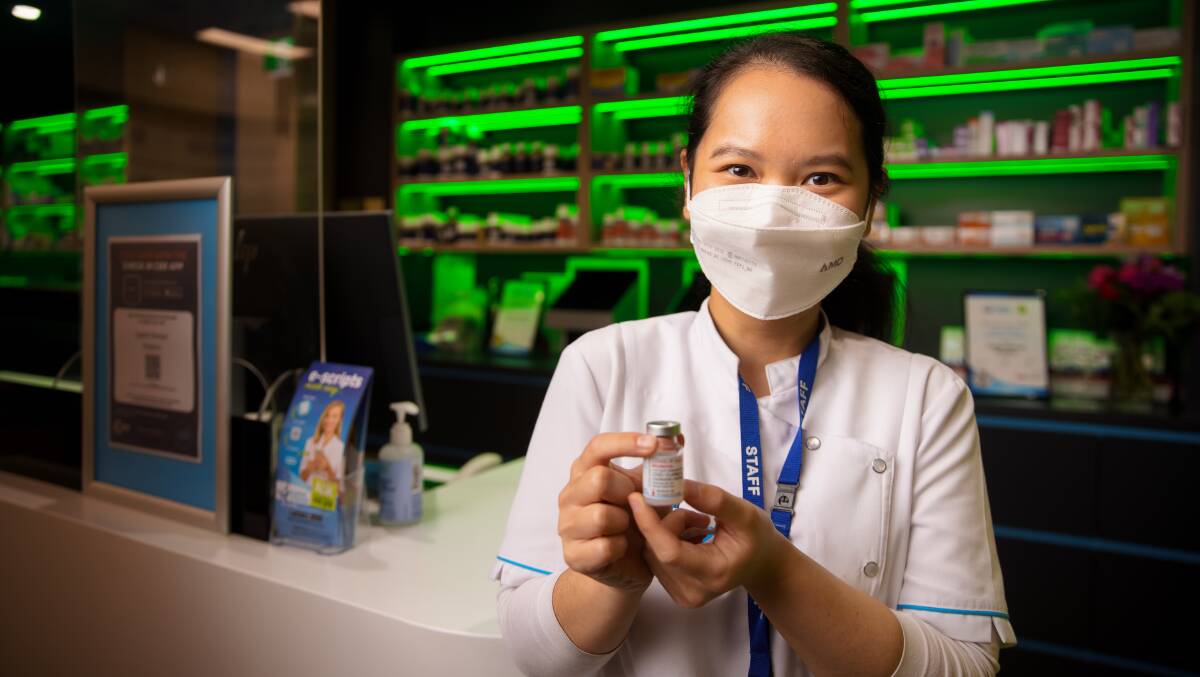 Capital Chemist Kingston pharmacist Yuh-Lin Gan ready to administer booster shots as she holds a vial of the Moderna COVID-19 vaccine. Picture: Sitthixay Ditthavong