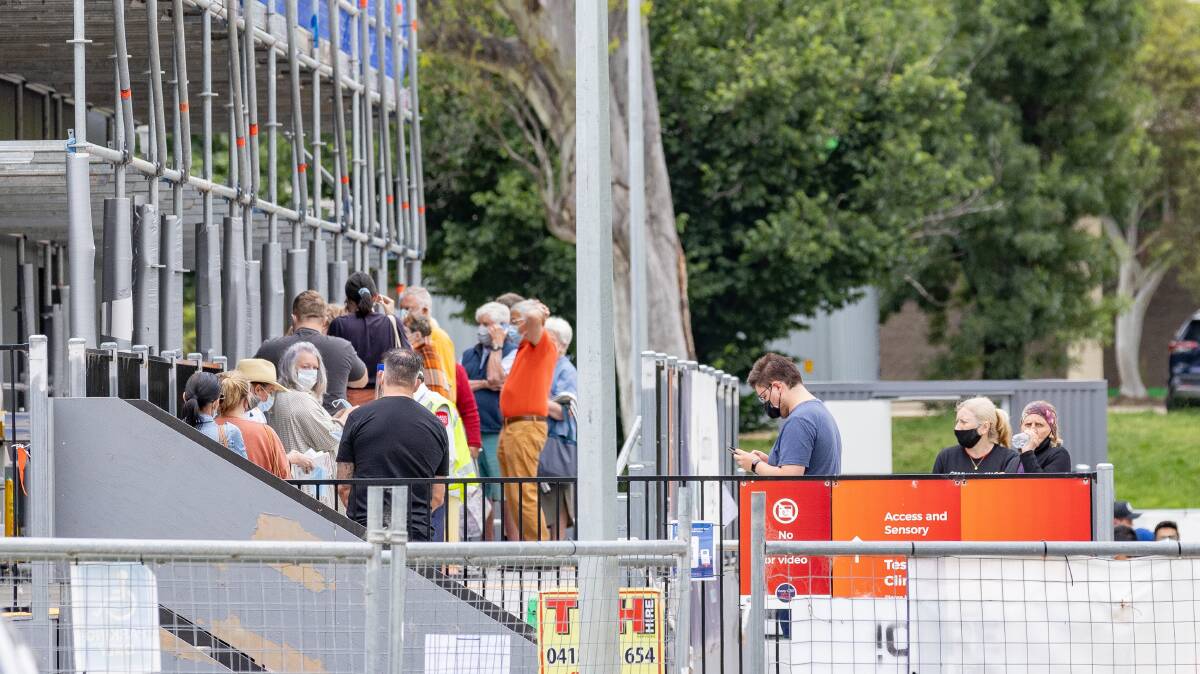 People wait outside the Garran Surge Centre. Picture by Sitthixay Ditthavong