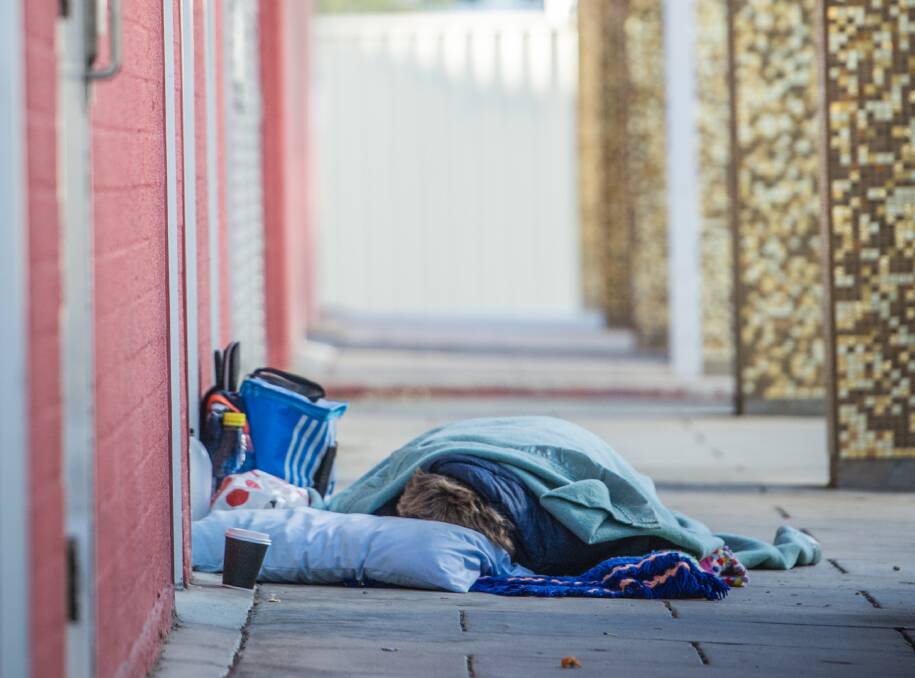 A homeless person sleeps tough outside the ACT Legislative assembly in September 2021. Picture: Karleen Minney