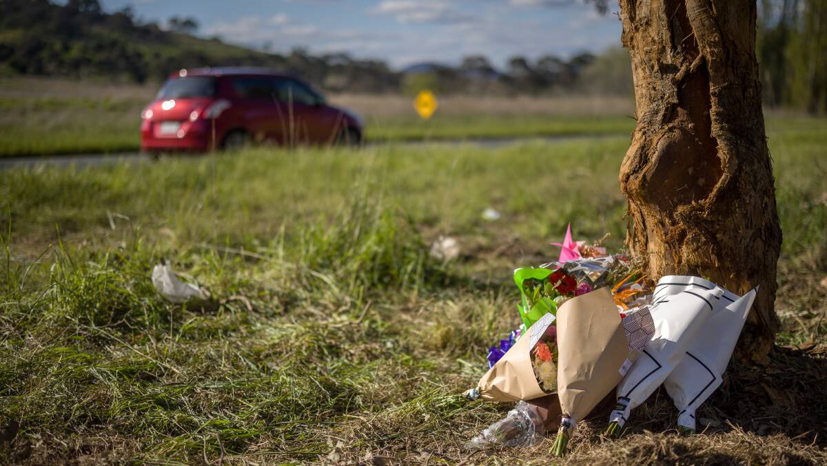 Flowers left at the scene of a crash on the Monaro Highway that claimed the lives of two teenage girls. Picture by Sitthixay Ditthavong