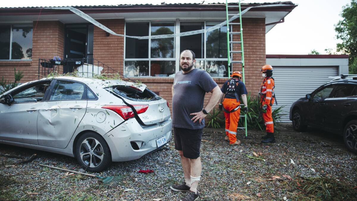 Gerry Satrapa whose living room and vehicle were damage after a severe thunderstorm swept through Belconnen, pictured in the suburb of Holt. Picture: Dion Georgopoulos 