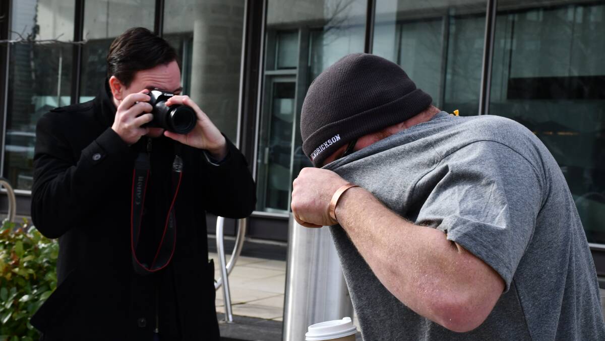 John Kirk, right, tries to hide from a reporter on a previous ocassion. Picture by Blake Foden
