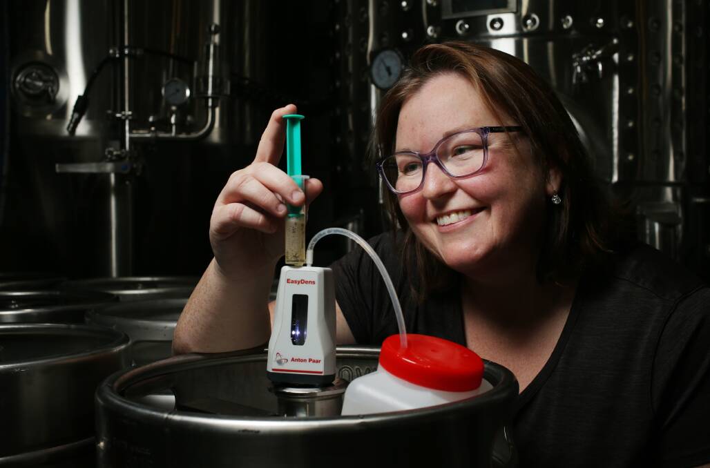 IronBark Hill co-owner Hayley Drayton tests the gravity of the beer. Picture by Simone De Peak