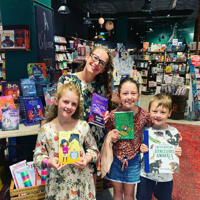 AVID READERS: A happy family enjoys a Love Your Bookshop event, Harry Hartog, at Warringhah Mall, Brookvale NSW.