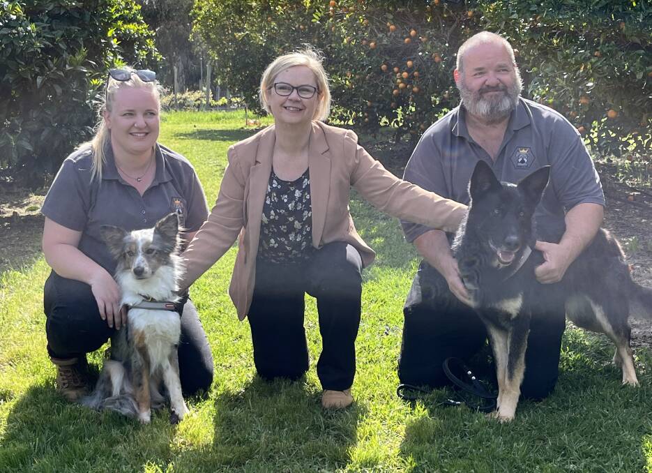 Gemma Wood with Max, Primary Industries Minister Clare Scriven and Danny Wood with Rylee, with the newly-graduated dogs ready to tackle the Riverland orchards.