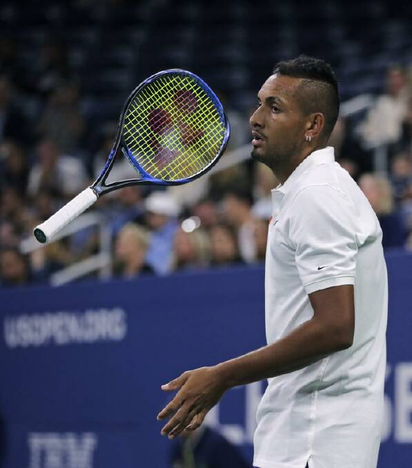 Nick Kyrgios, of Australia, flips his racket as he waits for Steve Johnson, of the United States, to serve.