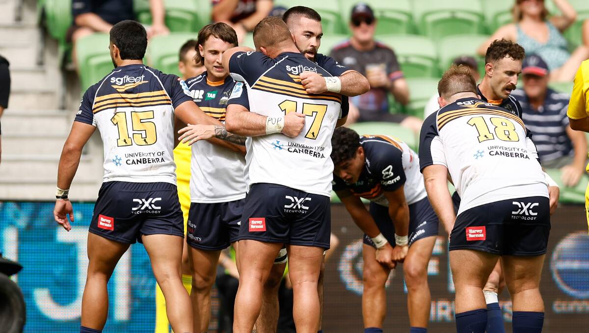 Exhausted Brumbies players celebrate Sunday's victory over the Auckland Blues. Picture Getty Images