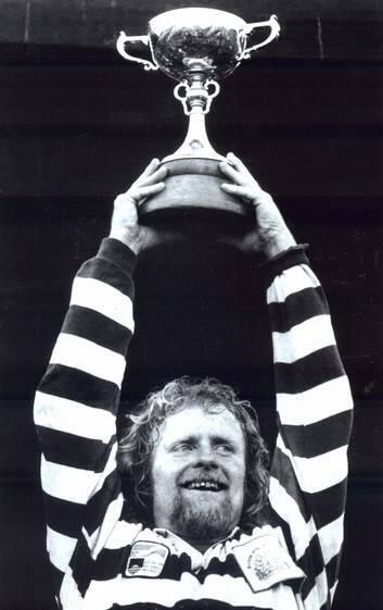 Laurie Fisher hoists the John I Dent Cup after ANU's 1992 grand final victory. Picture: Andrew Campbell
