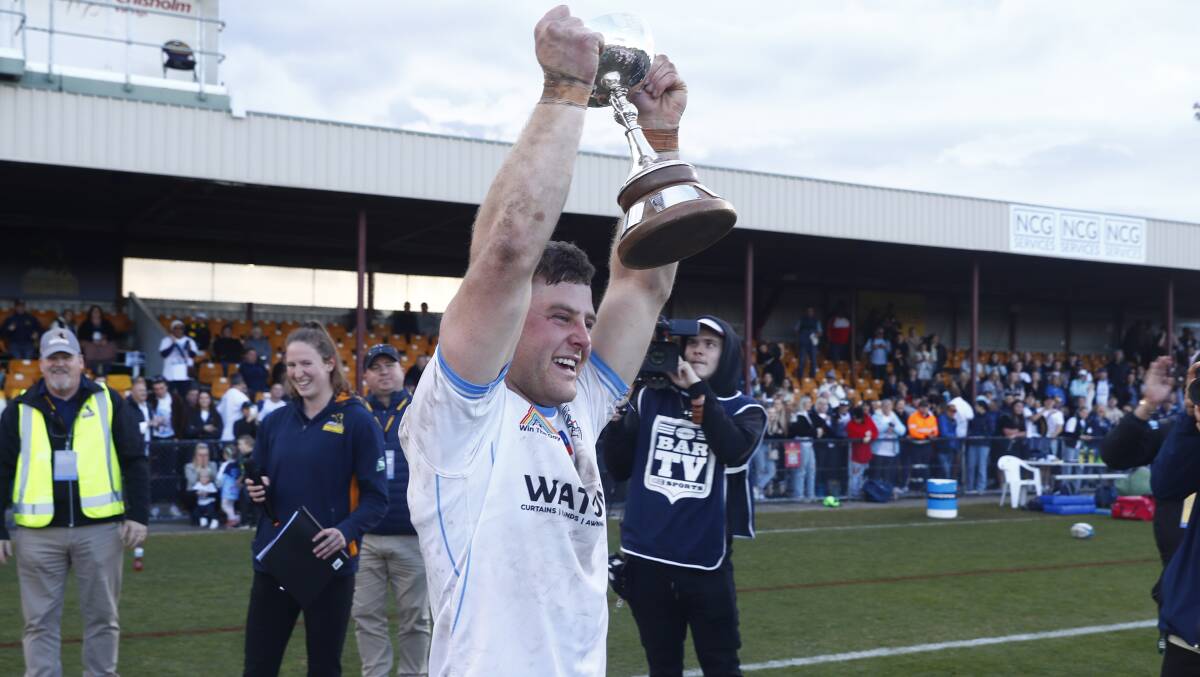 Whites captain Matt Taylor hoists the John I Dent Cup on Saturday afternoon. Picture by Keegan Carroll
